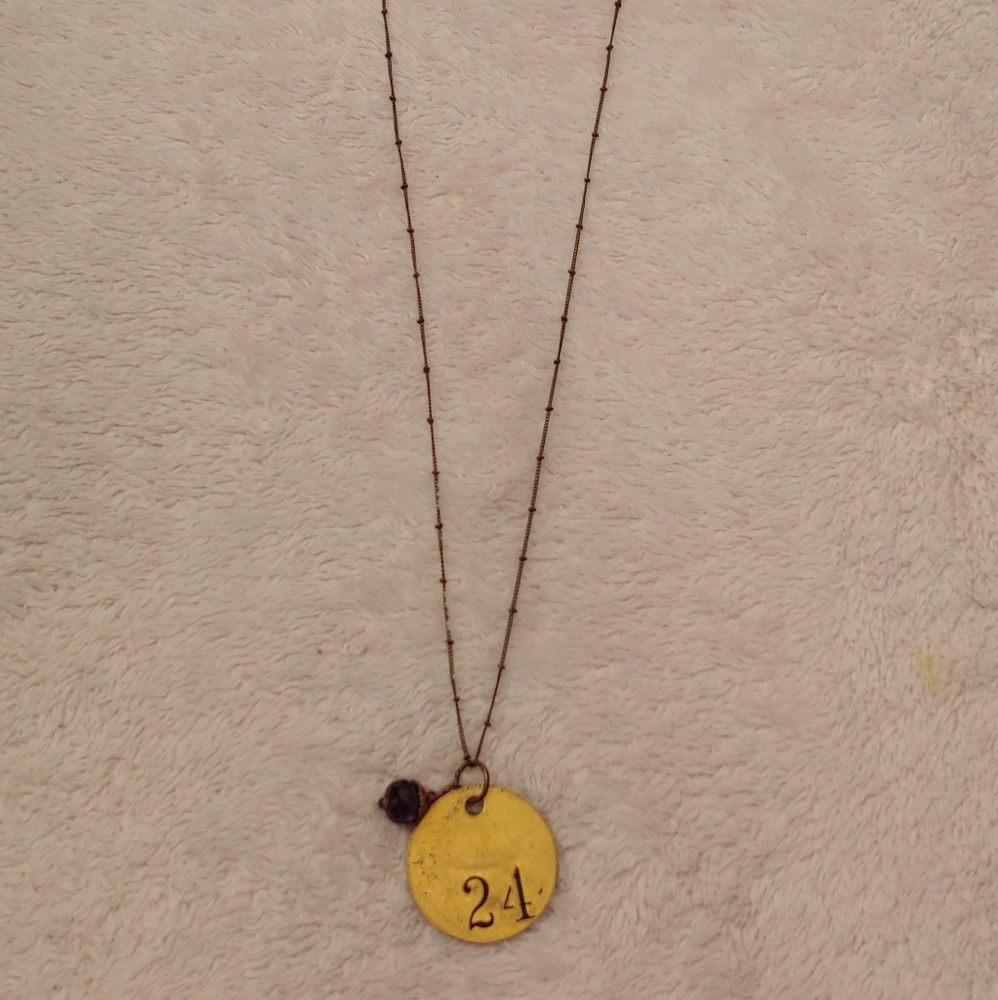 Pendant necklace gold and purple bead detail